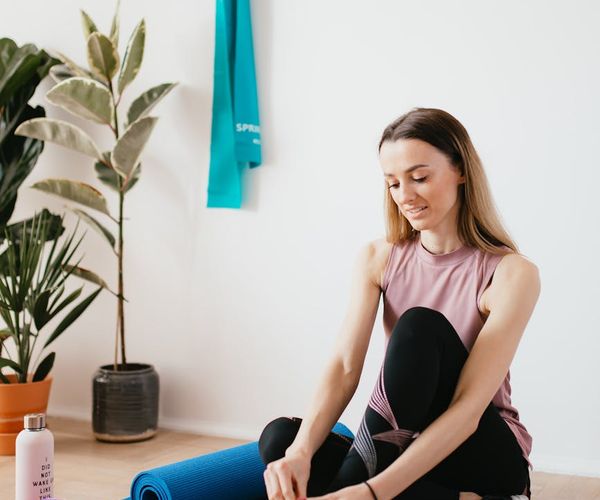 Yoga mat, water bottle and a small towel neatly arranged.